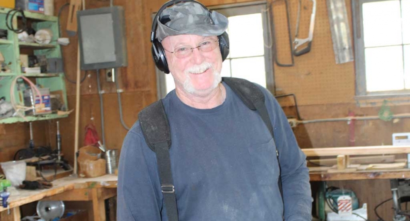 A person wearing ear protection during a service project with Outward Bound.